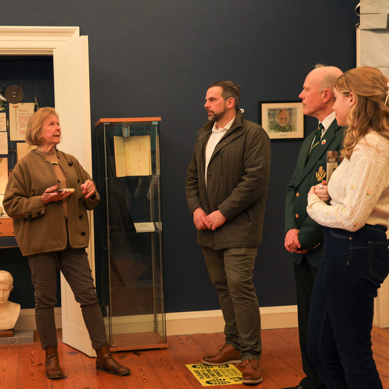 Group of visitors listening to a guide explaining an attraction