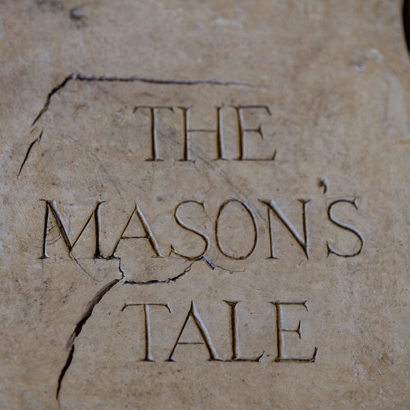 A close up of a masons stone sign feature