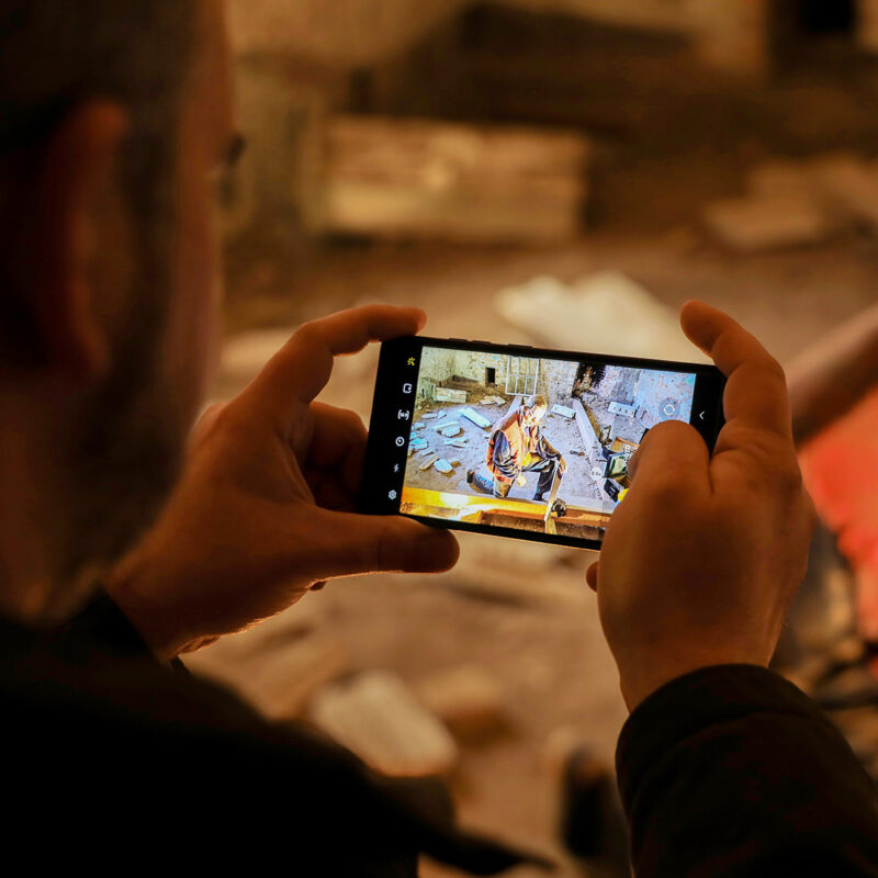 Visitor takes a photo of a mannequin with a smartphone